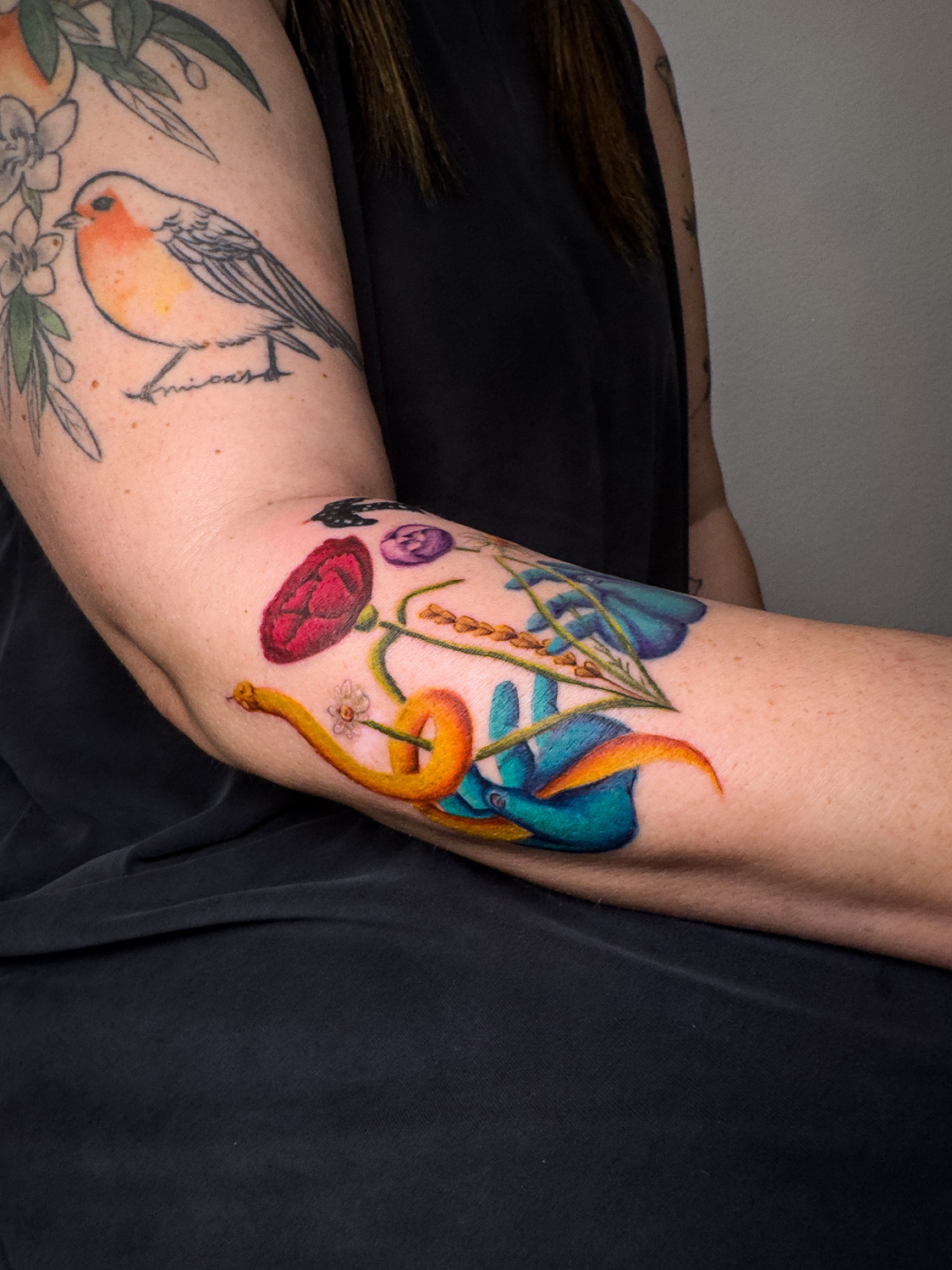Color-realism floral collage on bent arm with orange snake