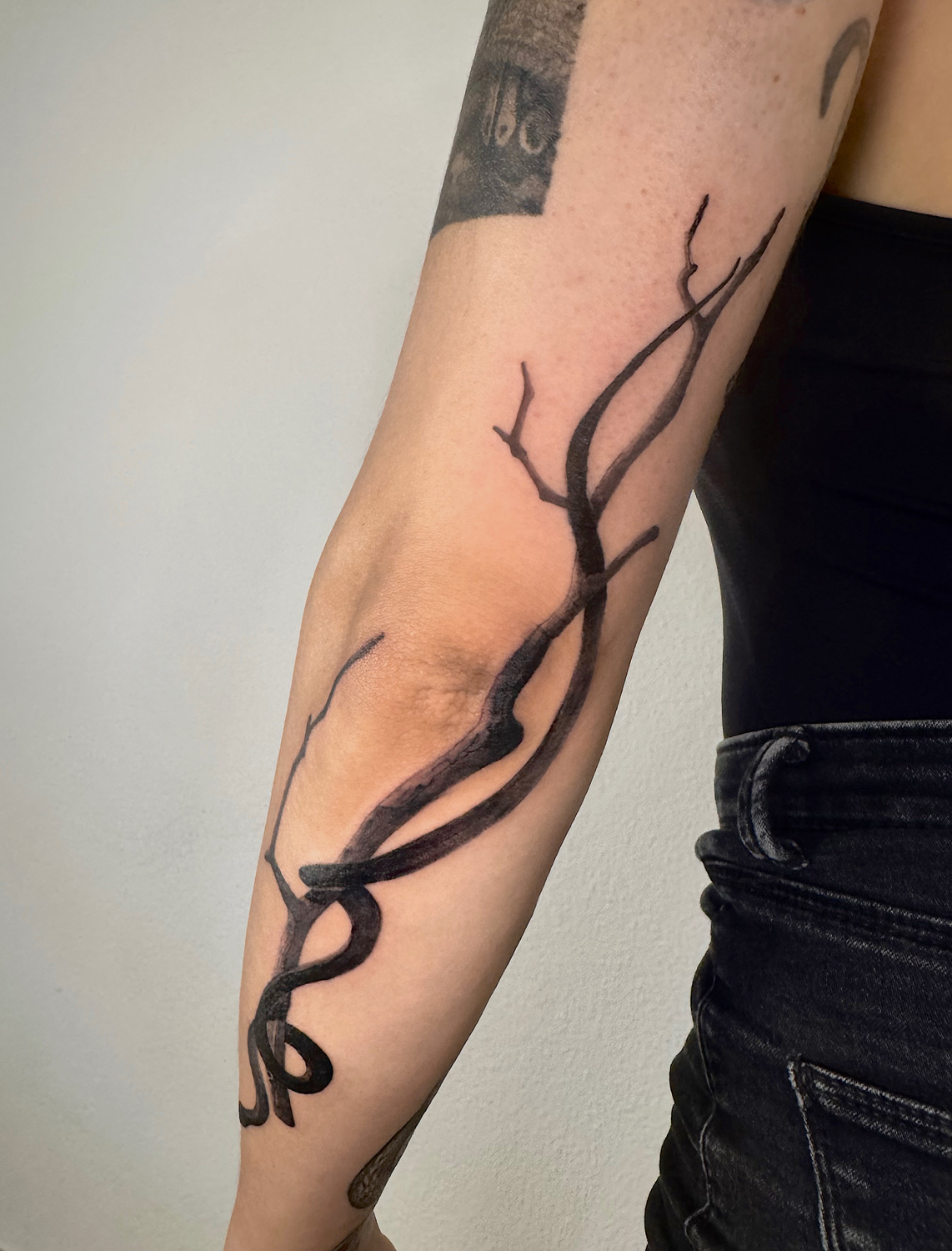 Snake on branch wrapping arm