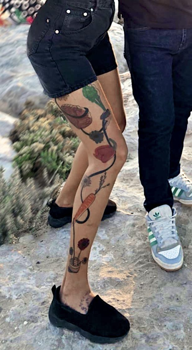 Vegetable and flower vine running down the leg