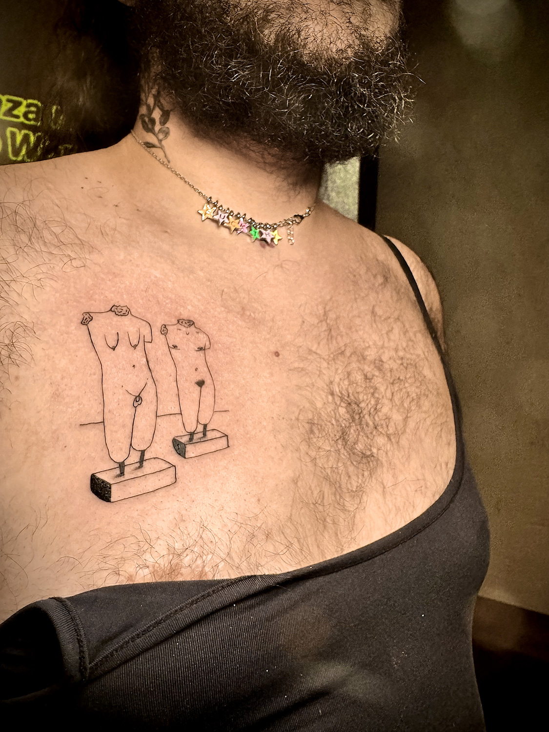 Twin sculpted bodies on chest