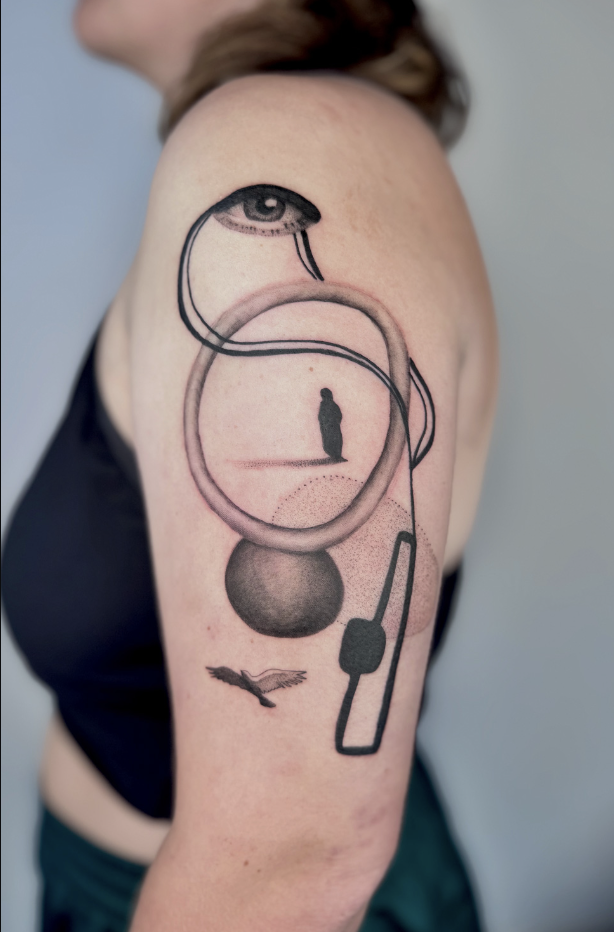 Surreal eye, snake and orbiting shapes on upper arm